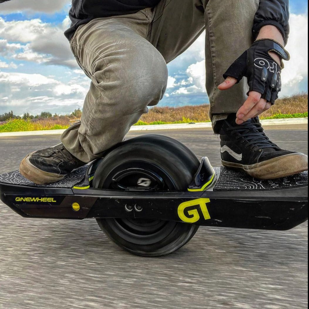 a man riding a black onewheel GT